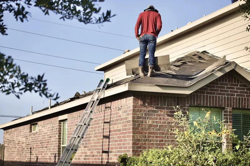 Professional roofer working on a residential roof in North Sagamore Heights